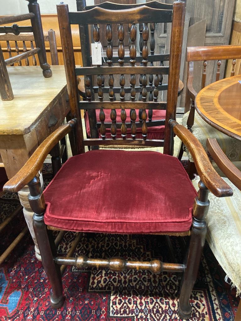 A harlequin set of eleven 19th century ash spindle back rush seat chairs
